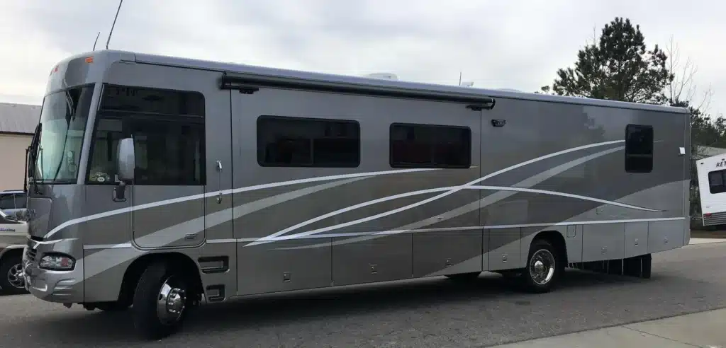 Finished result for collision repair of an RV body with custom paint.