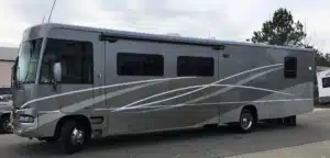 Finished result for collision repair of an RV body with custom paint.